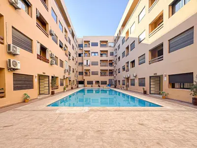 a swimming pool in the middle of a building at Oasis Gueliz - Piscine & parking privé in Marrakech