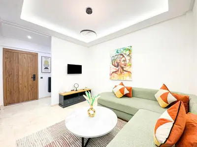 a living room with a couch and a table at Oasis Gueliz - Piscine & parking privé in Marrakech