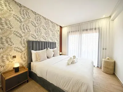 a bedroom with a large bed with white sheets at Oasis Gueliz - Piscine & parking privé in Marrakech