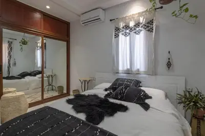 a bedroom with two beds and a large mirror at Dar Choway in Marrakech