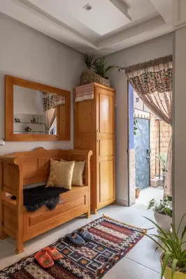 a bedroom with a wooden bed and a mirror at Dar Choway in Marrakech
