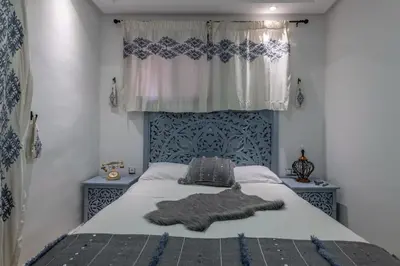 a bedroom with a bed with a blanket on it at Dar Choway in Marrakech