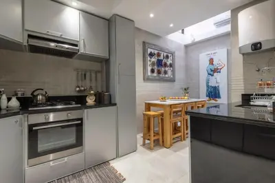 a kitchen with stainless steel appliances and a table at Dar Choway in Marrakech
