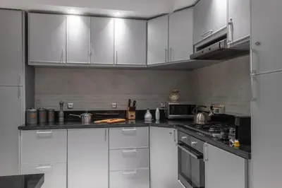 a kitchen with white cabinets and a stove at Dar Choway in Marrakech