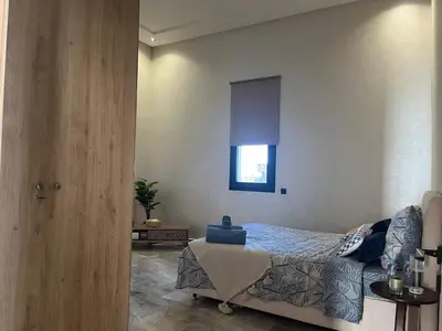 a bedroom with a bed and a window at Villa Lam in Marrakech