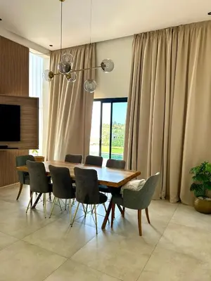 a dining room with a wooden table and chairs at Villa Lam in Marrakech