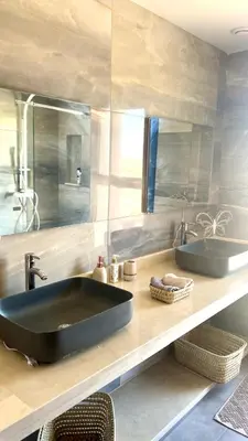 a bathroom with a large black sink and a mirror at Villa Lam in Marrakech