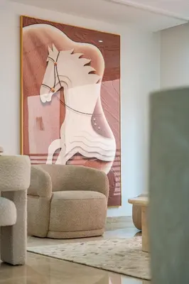 a living room with a painting of a horse on the wall at Appartement Deluxe 2 chambres GUELIZ, Piscines, Spa, Gym in Marrakech