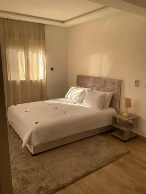 a bedroom with a large bed with white sheets and pillows at jhome in Marrakech