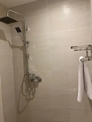 a shower in a bathroom with white towels at jhome in Marrakech