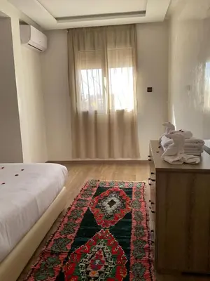 a bedroom with a bed and a rug on the floor at jhome in Marrakech