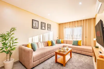 a living room with a couch and a table at Warm Nest 8 Comfort And Luxury in Oulad Akkou