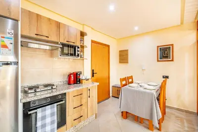 a kitchen with a table and a stove top oven at Warm Nest 8 Comfort And Luxury in Oulad Akkou