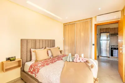 a bedroom with a bed with two stuffed animals on it at Warm Nest 8 Comfort And Luxury in Oulad Akkou
