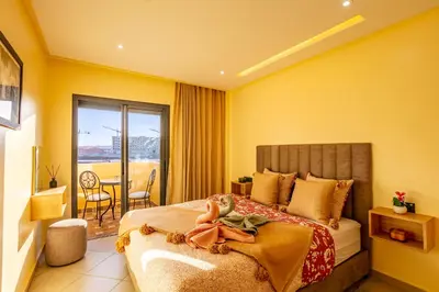 a hotel room with a bed and a balcony at Warm Nest 8 Comfort And Luxury in Oulad Akkou