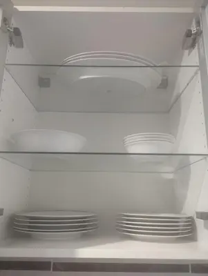 a white refrigerator with empty shelves and plates at Appartement cosy Marrakech in Marrakech