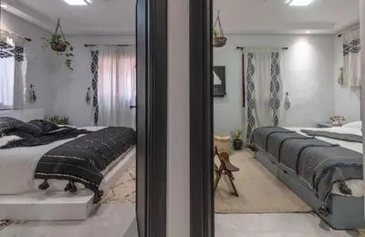 a bedroom with two beds and a mirror at Dar Choway Ground Floor Apartment in Marrakech