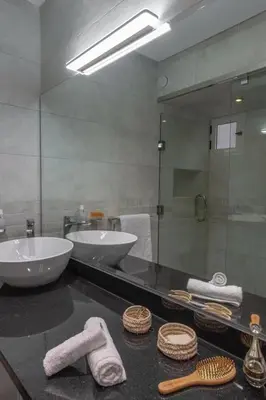 a bathroom with two sinks and a large mirror at Dar Choway Ground Floor Apartment in Marrakech
