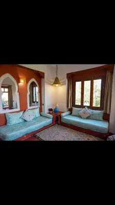 a bedroom with two beds and a mirror at RIAD SYMPA dans residence in Marrakech