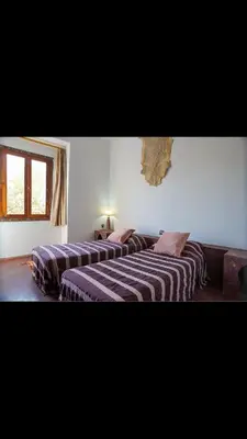 two beds are lined up in a room at RIAD SYMPA dans residence in Marrakech