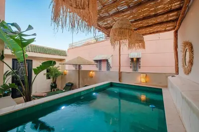 a swimming pool in the backyard of a house at Riad Sohayna with Rooftop Pool 3BR Oasis in Marrakech