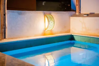 a swimming pool with a light on the side at Riad Sohayna with Rooftop Pool 3BR Oasis in Marrakech