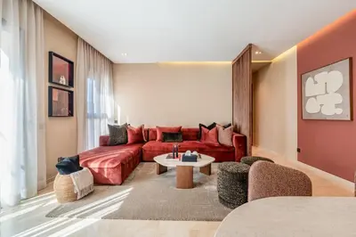 a living room with a red couch and a table at Magnifique appt Hivernage Gueliz in Marrakech