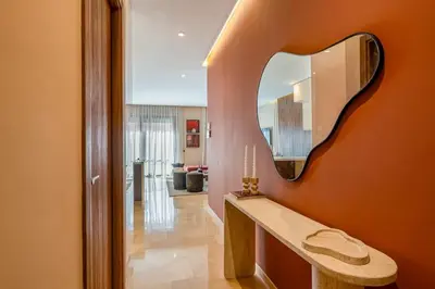 a hallway with a mirror on a wall at Magnifique appt Hivernage Gueliz in Marrakech