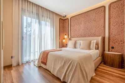 a bedroom with a large bed and a large window at Magnifique appt Hivernage Gueliz in Marrakech