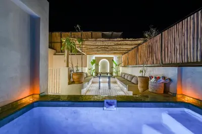 a swimming pool in the middle of a house at Riad Exotika a Oasis with Pool, 7 min to Jemaa El Fna in Marrakech