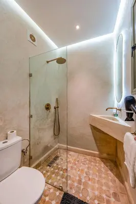 a bathroom with a shower and a toilet and a sink at Riad Exotika a Oasis with Pool, 7 min to Jemaa El Fna in Marrakech