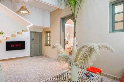 a living room with a staircase and a plant at Riad Exotika a Oasis with Pool, 7 min to Jemaa El Fna in Marrakech