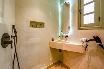 a bathroom with a sink and a mirror at Riad Exotika a Oasis with Pool, 7 min to Jemaa El Fna in Marrakech