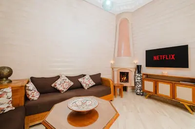 a living room with a couch and a fireplace at Riad Marrakech Oasis complexe in Marrakech