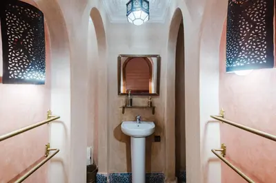 a bathroom with a sink and a mirror at Riad Marrakech Oasis complexe in Marrakech
