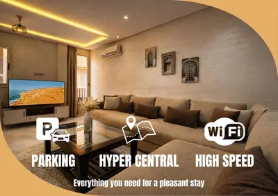 a living room with a couch and a tv at Studio Chic & Haut Standing - Parking Gratuit in Marrakech