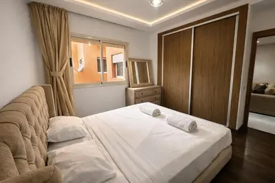 a bedroom with a bed with two pillows on it at Studio Chic & Haut Standing - Parking Gratuit in Marrakech