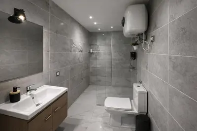 a bathroom with a toilet and a sink and a mirror at Studio Chic & Haut Standing - Parking Gratuit in Marrakech