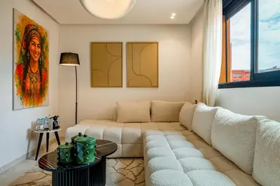 a living room with a couch and a table at Élégance et Confort au Centre de Marrakech - Hivernage in Marrakech