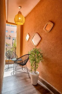 a patio with a potted plant and a pendant light at Élégance et Confort au Centre de Marrakech - Hivernage in Marrakech
