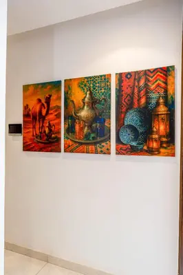 a group of paintings hanging on a wall at Élégance et Confort au Centre de Marrakech - Hivernage in Marrakech