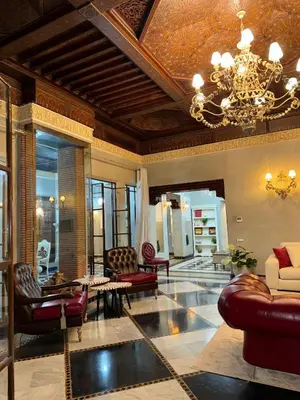 a large living room with a chandelier and furniture at Golf mountain camels sereine holiday treat in Marrakech