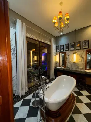 a bathroom with a bath tub in a room at Golf mountain camels sereine holiday treat in Marrakech