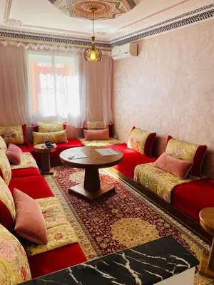 a living room with couches and a table at Moroccan-style apartment rental in Marrakech in Marrakech