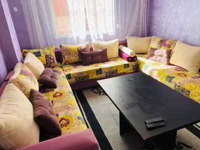 a living room with a couch and a table at Moroccan-style apartment rental in Marrakech in Marrakech