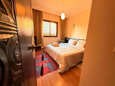 a bedroom with a bed and a window at Gueliz 2 BR Duplex - Terrace - Wi-Fi - Train station in Marrakech