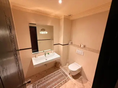 a bathroom with a sink and a toilet and a mirror at Gueliz 2 BR Duplex - Terrace - Wi-Fi - Train station in Marrakech