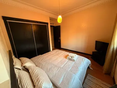 a bedroom with a bed with two pillows on it at Gueliz 2 BR Duplex - Terrace - Wi-Fi - Train station in Marrakech