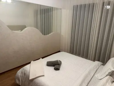 a bedroom with a bed with a stuffed animal on it at Luxury Noria Apartment - Pool - Security - airport in Oulad Akkou