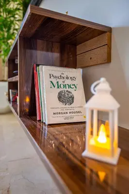 a book sitting on a table next to a candle at Chic Majorelle Apartment with Balcony and city view Central & Calm Marrakech in Marrakech